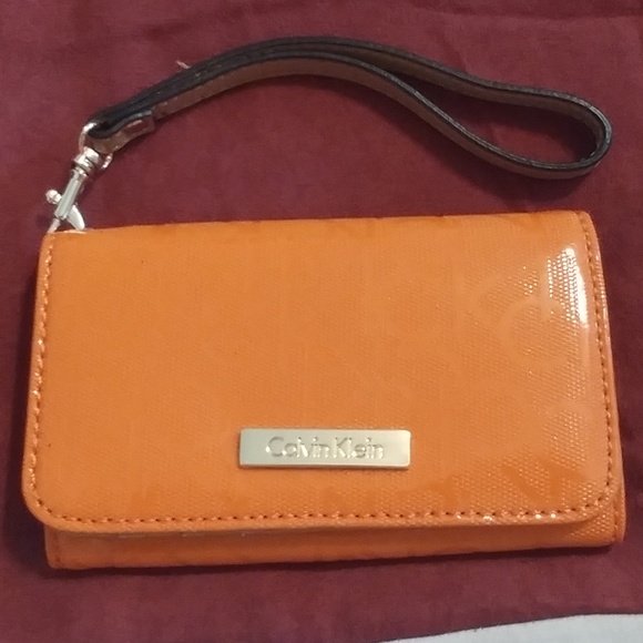 Calvin Klein Handbags - CALVIN KLEIN ORANGE SIGNATURE WRISTLET WAS $14